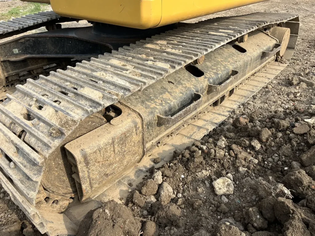 Used 2022 CAT 320GC excavator, track chain and lower roller detail