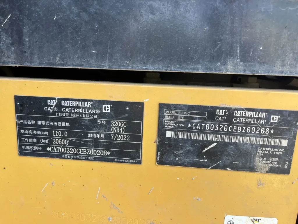 Used 2022 CAT 320GC excavator, machine identification plate showing model 320GC (NR4), build date 7/2022, 20,600 kg operating weight and serial number CAT00320CEBZ00208