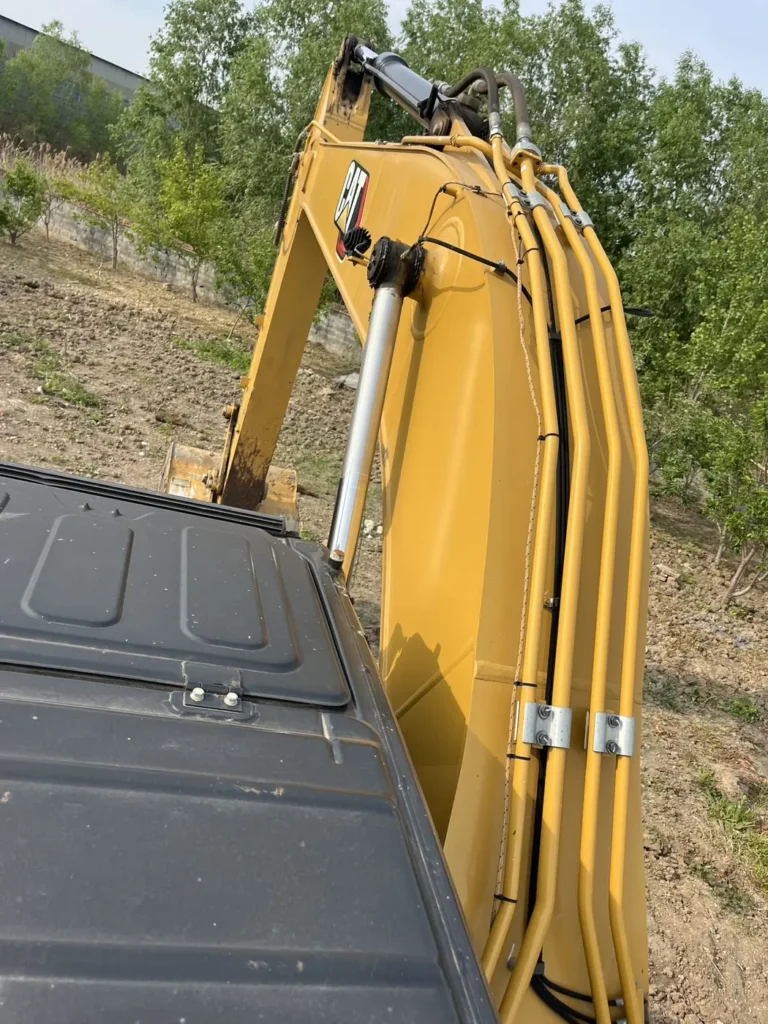 Used 2022 CAT 320GC excavator, boom hose routing and clamp detail