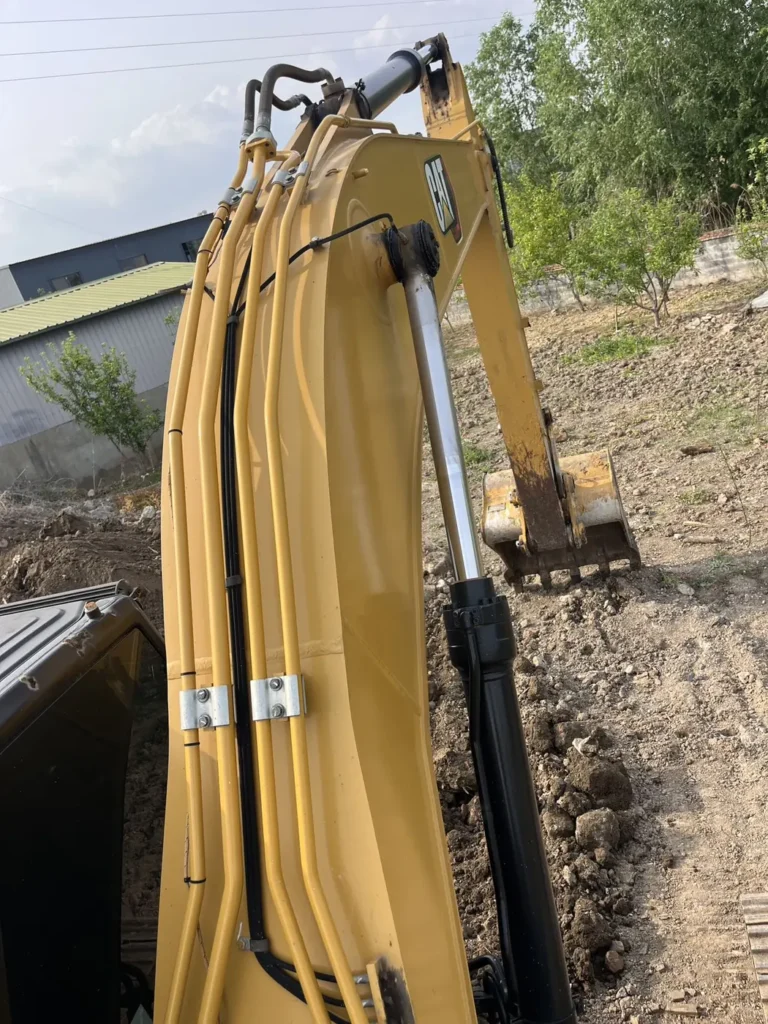Used 2022 CAT 320GC excavator, boom, hydraulic lines and cylinder from above