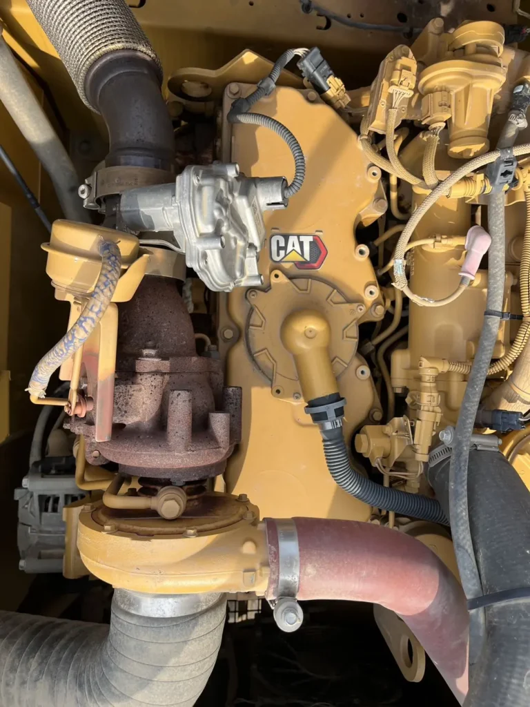 Used 2022 CAT 320GC excavator, engine bay showing the turbocharger and CAT engine plate