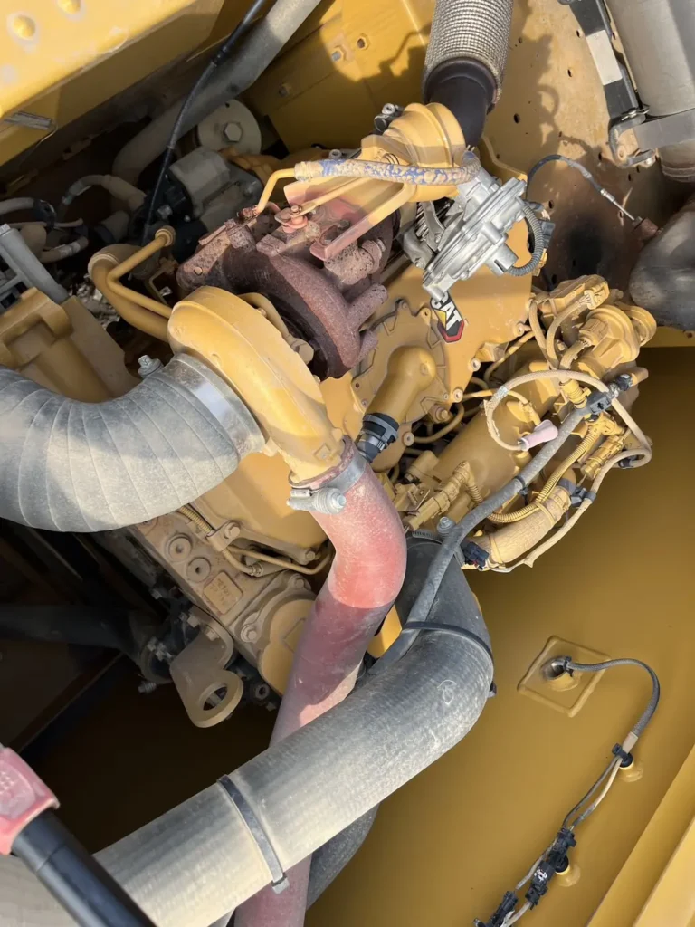 Used 2022 CAT 320GC excavator, engine bay from the exhaust and intake side